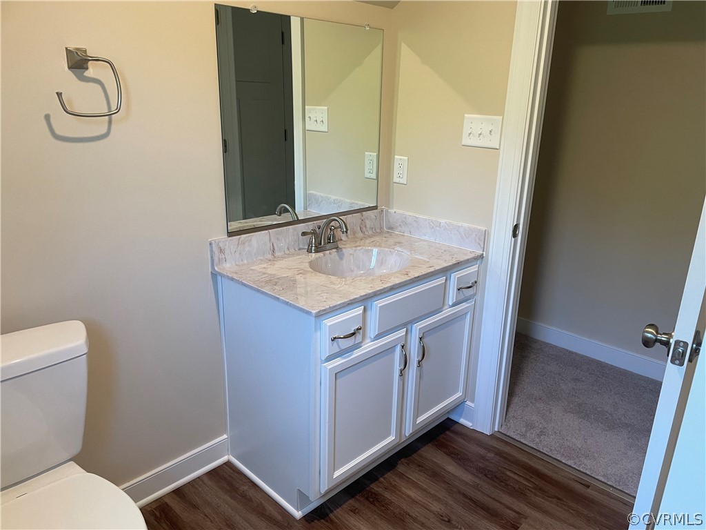 737 Rainbow Ridge Bumpass, VA 23024 - Photo 36 of 45 a bathroom with a granite countertop sink toilet and mirror