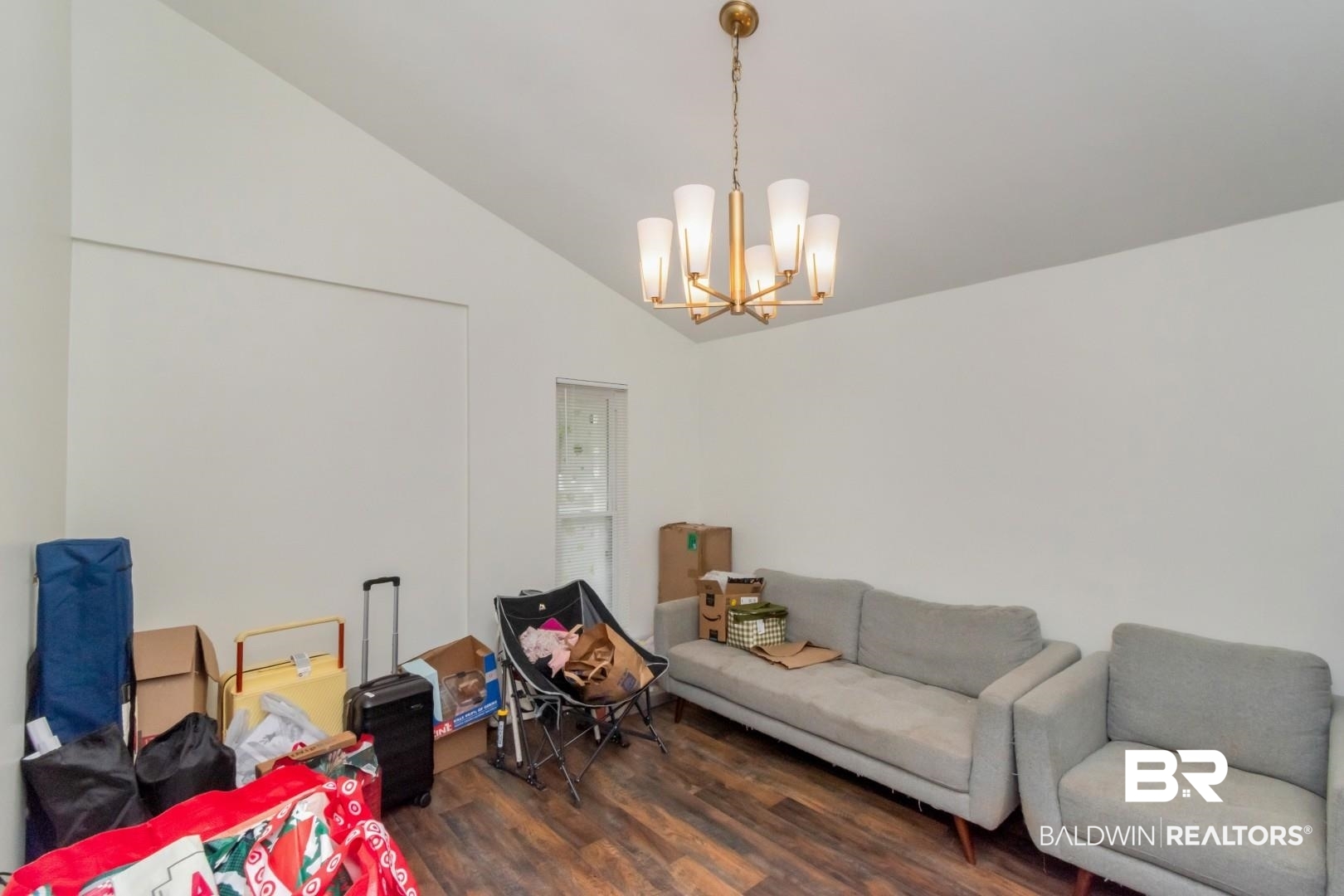 6208 Cottage Hill Road Mobile, AL 36609 - Photo 13 of 20 Living area featuring dark wood-type flooring, hanging lights, and vaulted ceiling