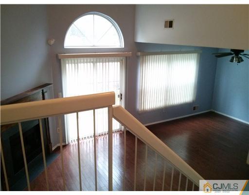 202 Nebula Road Piscataway, NJ 08854 - Photo 4 of 14 a view of an empty room with wooden floor and a window