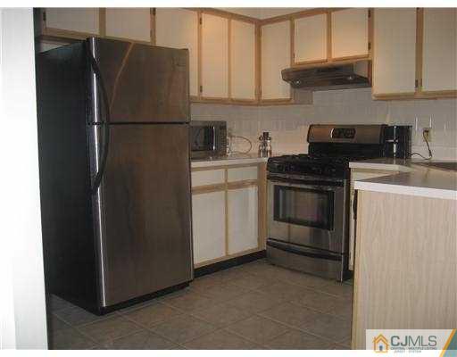 202 Nebula Road Piscataway, NJ 08854 - Photo 6 of 14 a white refrigerator freezer and a stove sitting inside of a kitchen