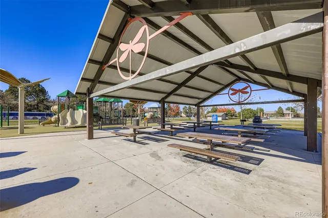 a view of patio with a table and chairs under an umbrella