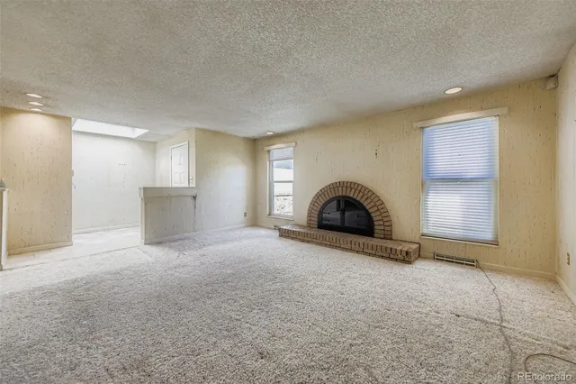 a view of empty room with a fireplace