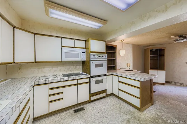 a kitchen with stainless steel appliances granite countertop a stove and a sink