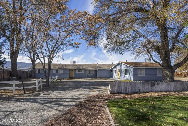 a view of house with backyard and trees
