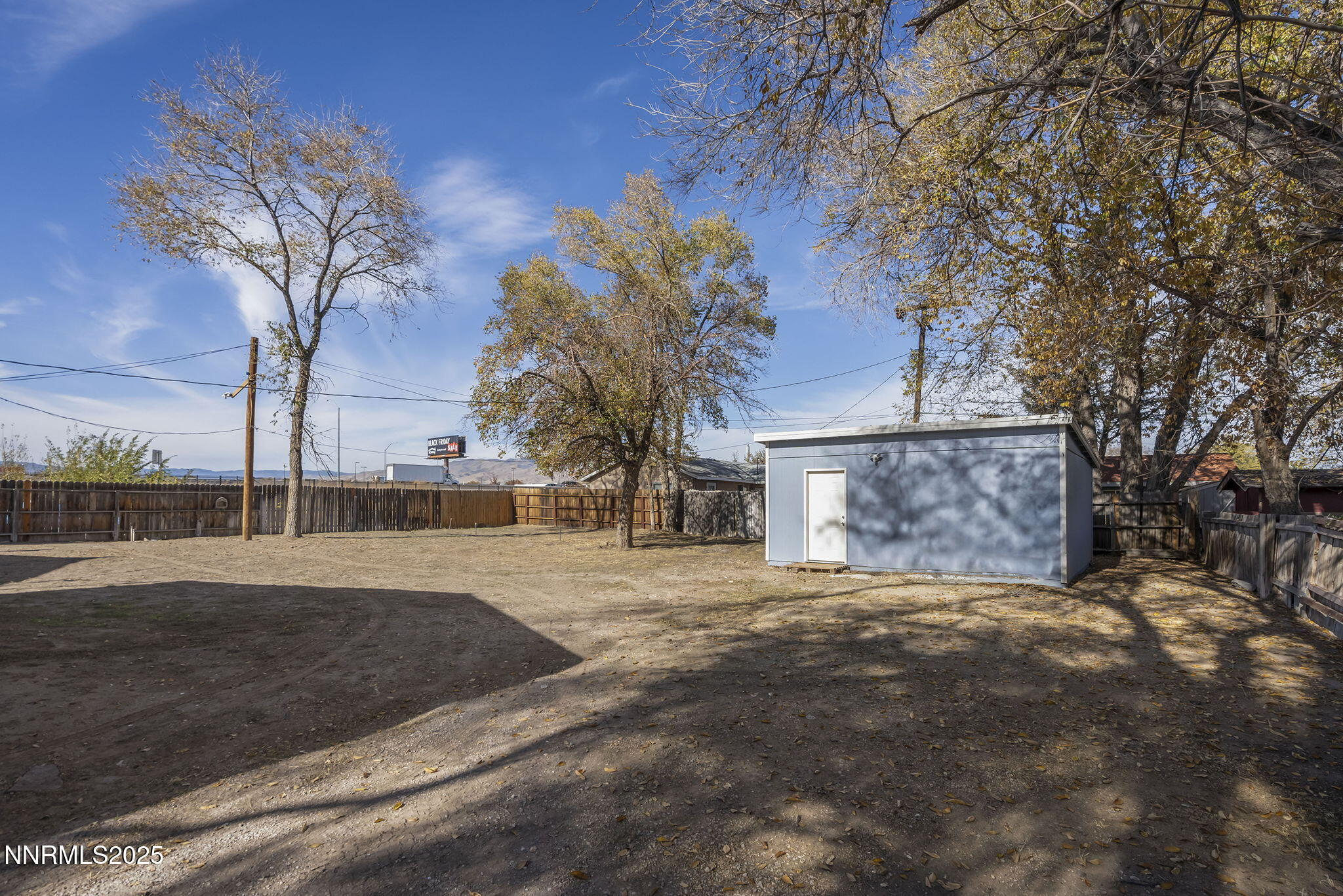 905 Mauldin Lane Reno, NV 89502 - Photo 15 of 21 a view of dirt yard with large trees