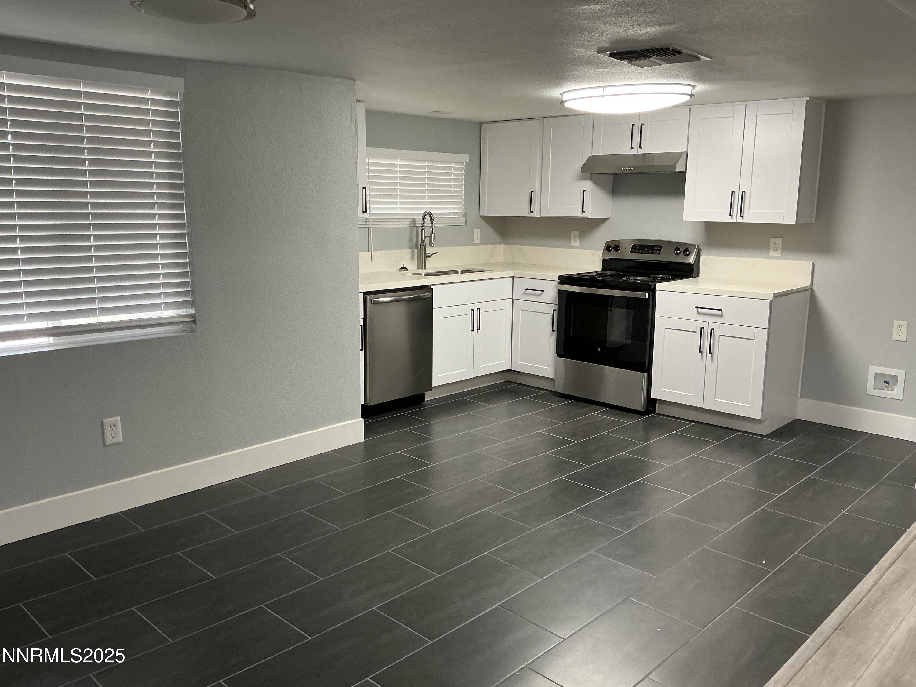 905 Mauldin Lane Reno, NV 89502 - Photo 2 of 21 a kitchen with a sink a stove and cabinets