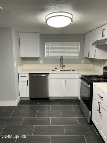 a kitchen with a sink a stove a microwave and cabinets