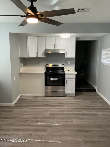 a kitchen with stainless steel appliances granite countertop a stove and a refrigerator