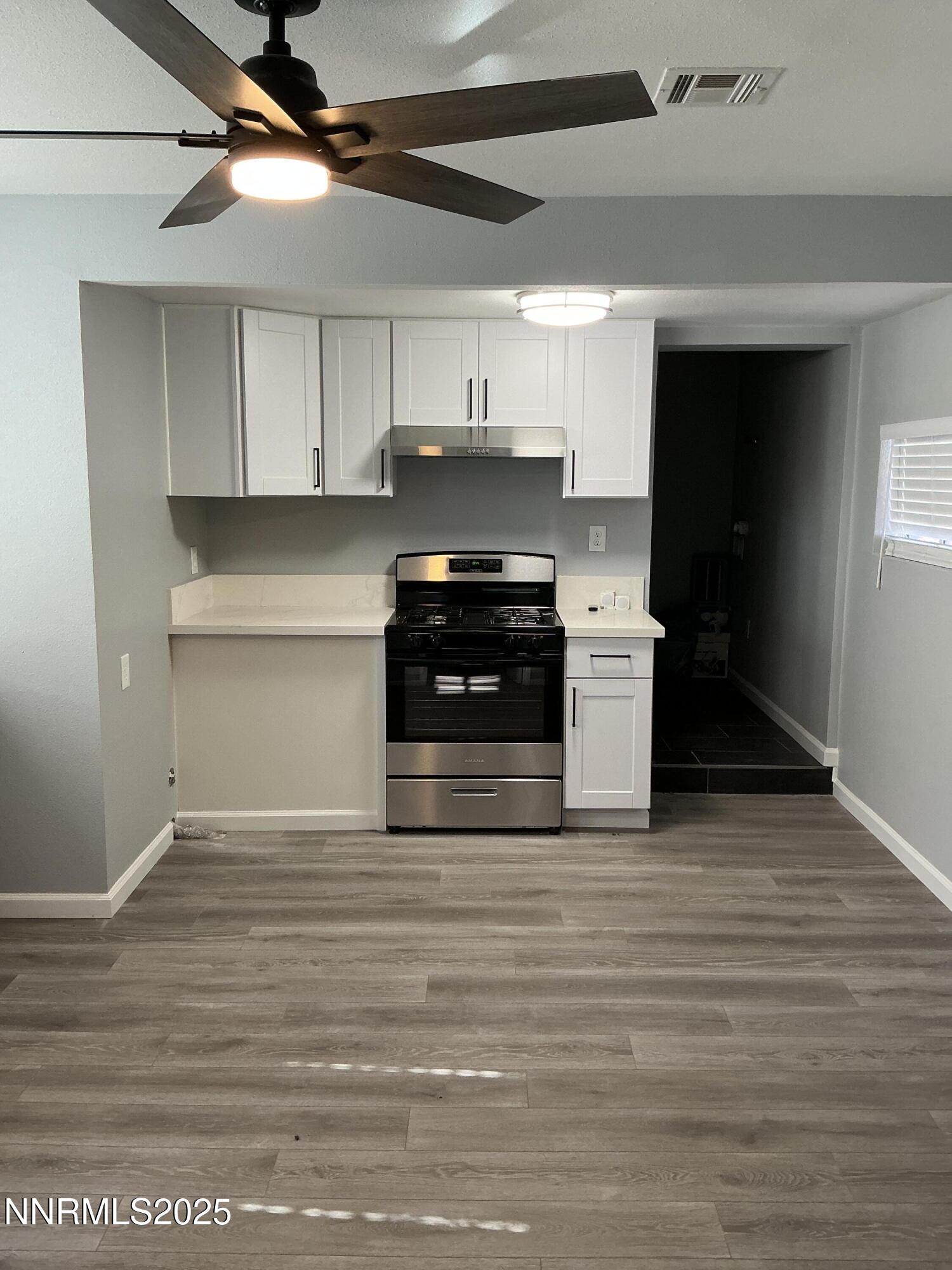 905 Mauldin Lane Reno, NV 89502 - Photo 9 of 21 a kitchen with stainless steel appliances granite countertop a stove and a refrigerator