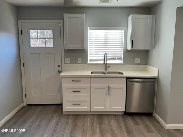 a kitchen with granite countertop white cabinets and white appliances