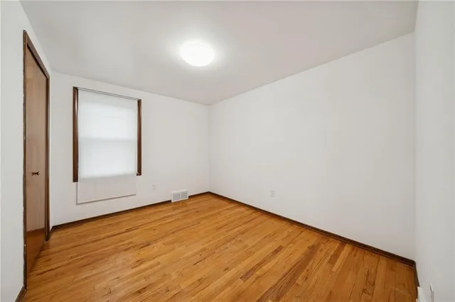 a view of an empty room and wooden floor