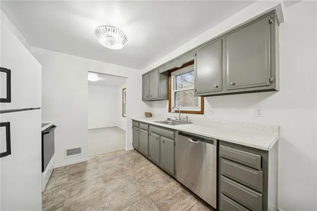 a kitchen with a sink and cabinets
