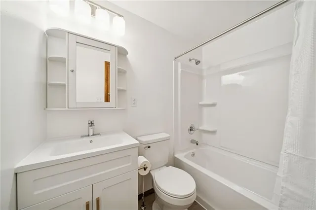 a view of a room with wooden floor and natural light