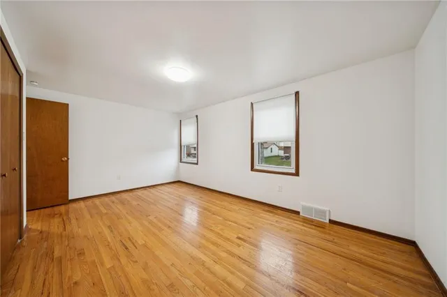 a view of empty room with refrigerator