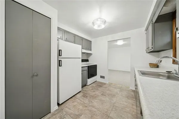 a kitchen with a refrigerator sink and stove
