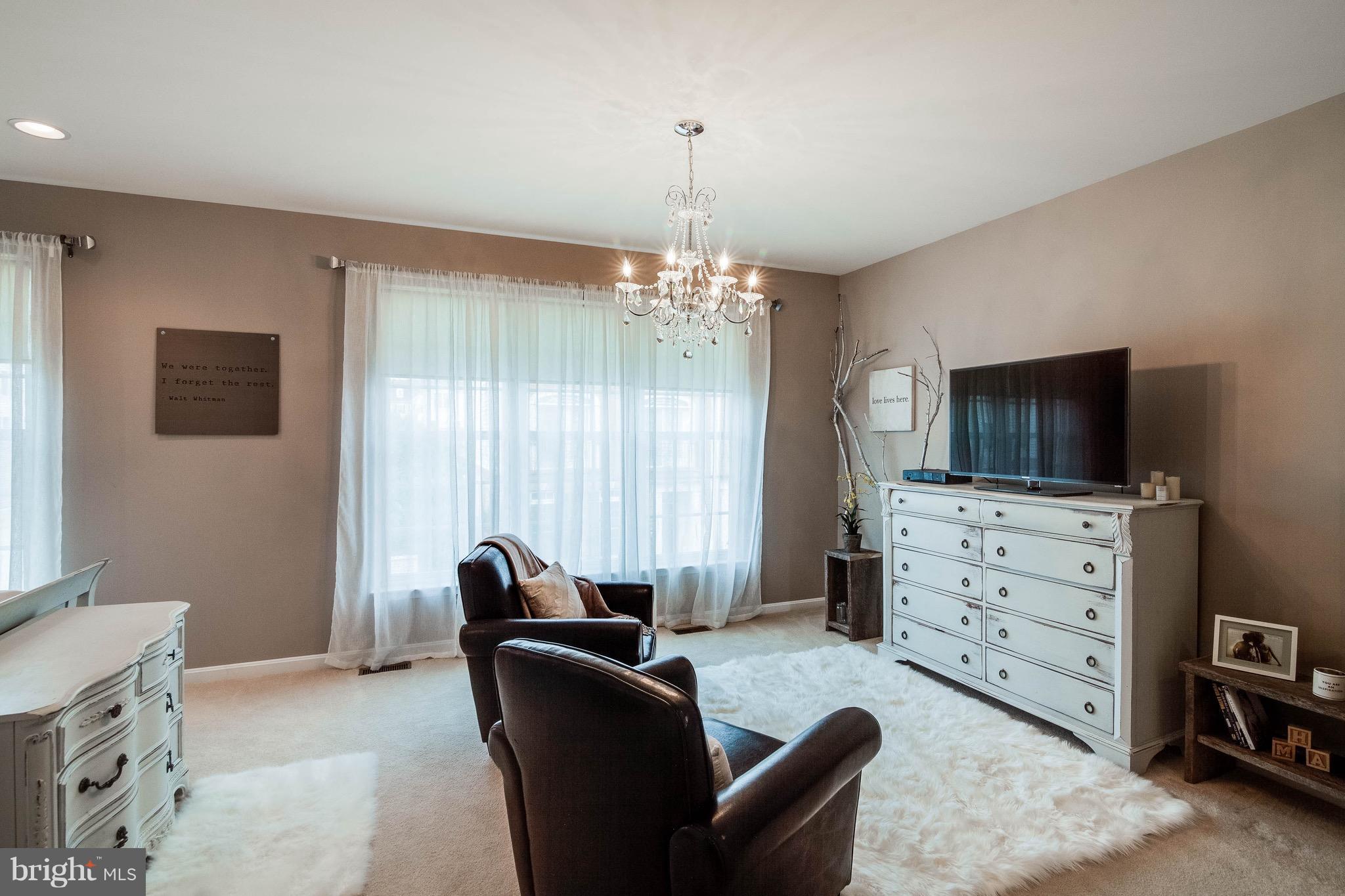 22960 Fanshaw Square Ashburn, VA 20148 - Photo 16 of 30 a living room with furniture a flat screen tv and a window