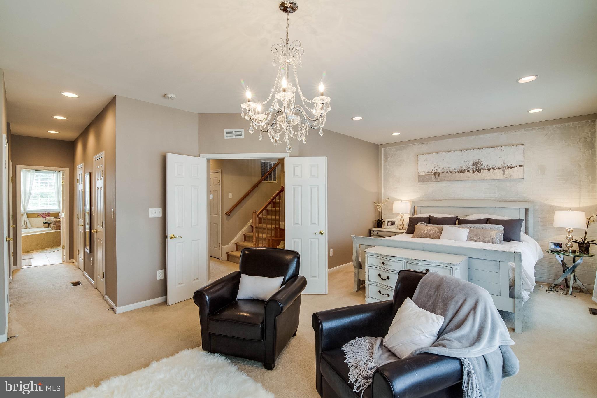 22960 Fanshaw Square Ashburn, VA 20148 - Photo 18 of 30 a living room with furniture a dining table and a chandelier