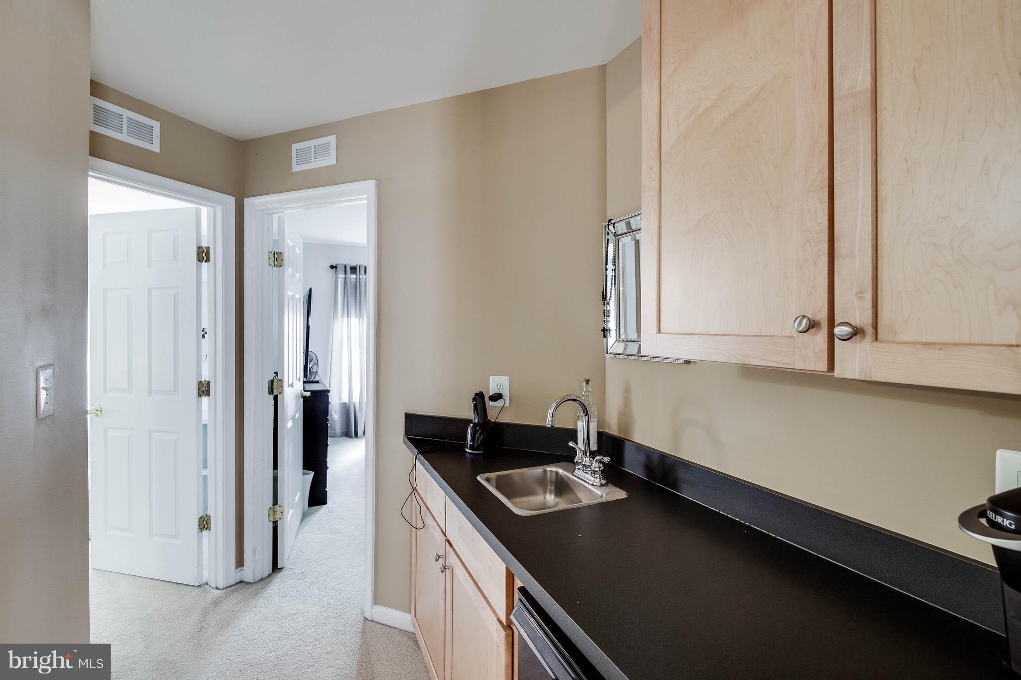 22960 Fanshaw Square Ashburn, VA 20148 - Photo 26 of 30 a kitchen with a sink and cabinets