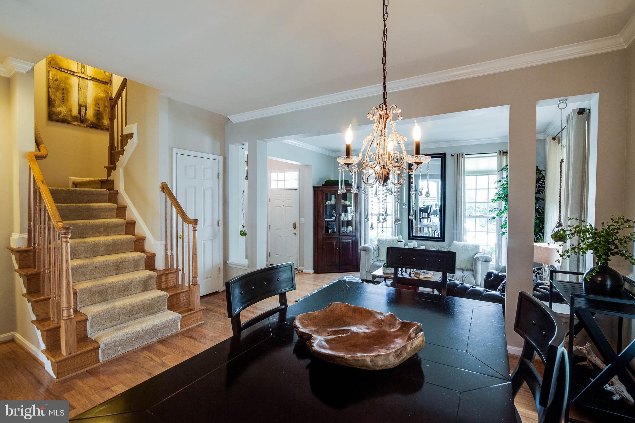 22960 Fanshaw Square Ashburn, VA 20148 - Photo 6 of 30 a living room with furniture and a chandelier