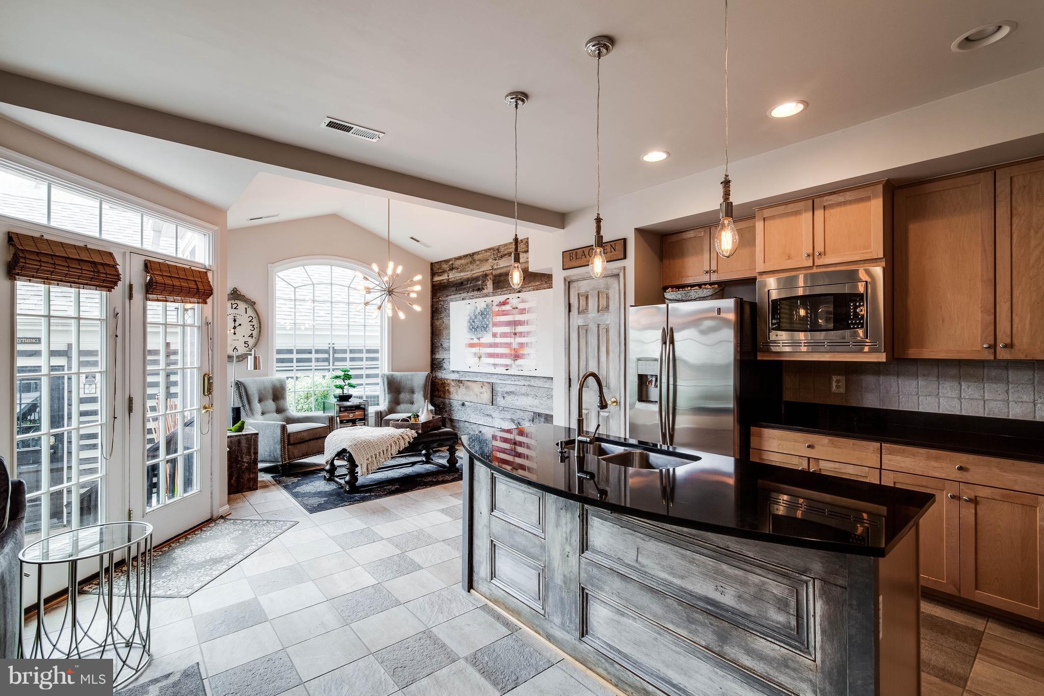 22960 Fanshaw Square Ashburn, VA 20148 - Photo 10 of 30 a large living room with stainless steel appliances granite countertop furniture a rug a fireplace and a window