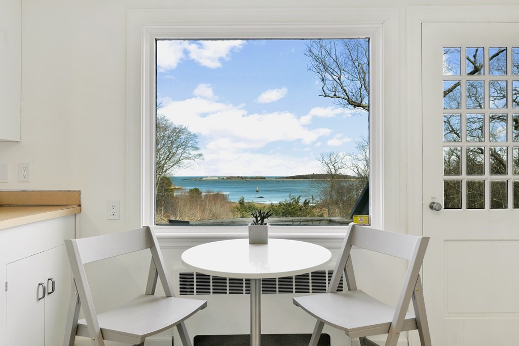 15 White Head Road Cohasset, MA 02025 - Photo 12 of 19 a view of a dining room with furniture large windows and wooden floor