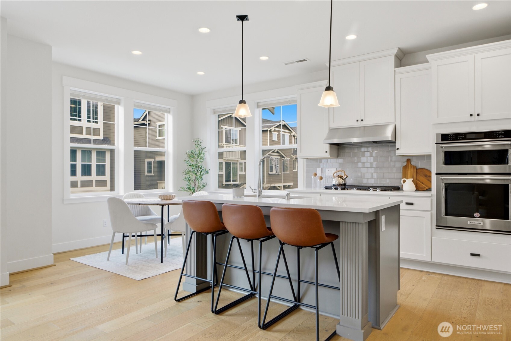 18615 46th Avenue Southeast Bothell, WA 98012 - Photo 11 of 37 a kitchen with stainless steel appliances granite countertop a stove a sink a refrigerator and chairs