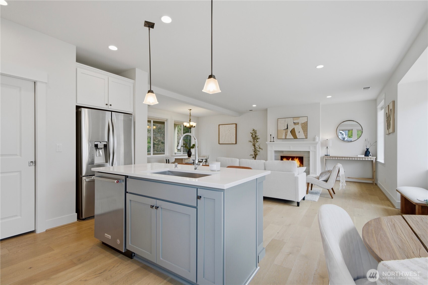 18615 46th Avenue Southeast Bothell, WA 98012 - Photo 19 of 37 a kitchen with stainless steel appliances granite countertop a refrigerator a sink dishwasher and white cabinets with wooden floor