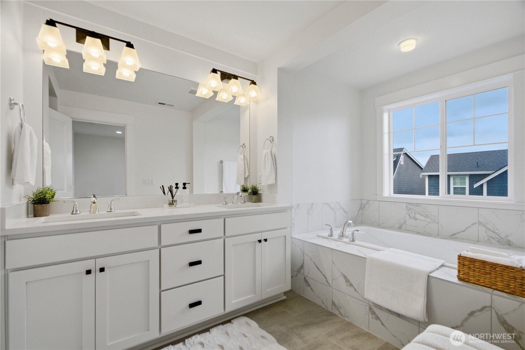 18615 46th Avenue Southeast Bothell, WA 98012 - Photo 25 of 37 a spacious bathroom with double vanity a mirror a vanity and a bathtub