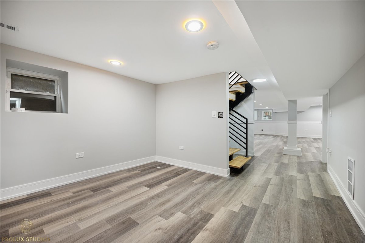 6637 South Marquette Road Chicago, IL 60637 - Photo 18 of 22 a bedroom with a bed and a chandelier