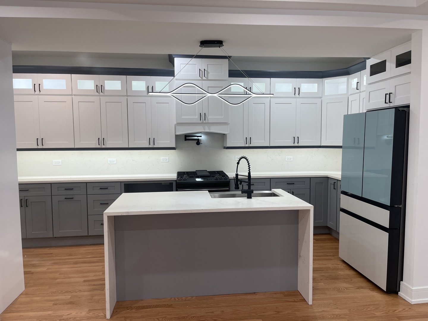 6637 South Marquette Road Chicago, IL 60637 - Photo 3 of 22 a kitchen with stainless steel appliances granite countertop a sink a refrigerator and wooden cabinets