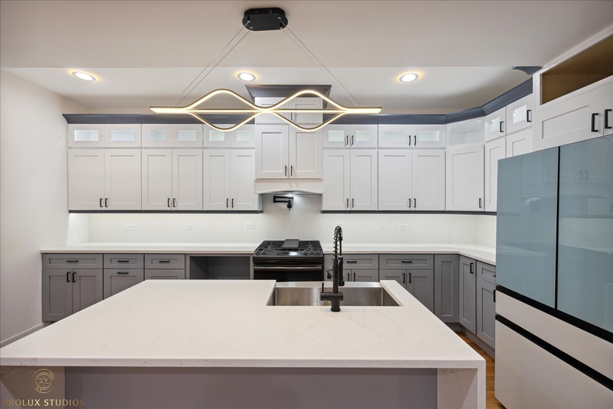 6637 South Marquette Road Chicago, IL 60637 - Photo 5 of 22 a kitchen with a sink a stove and refrigerator