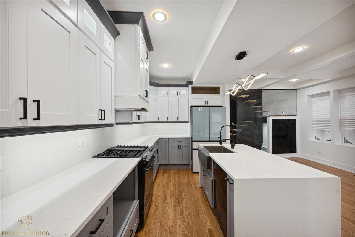 6637 South Marquette Road Chicago, IL 60637 - Photo 6 of 22 a kitchen with a sink a counter top space stainless steel appliances and cabinets