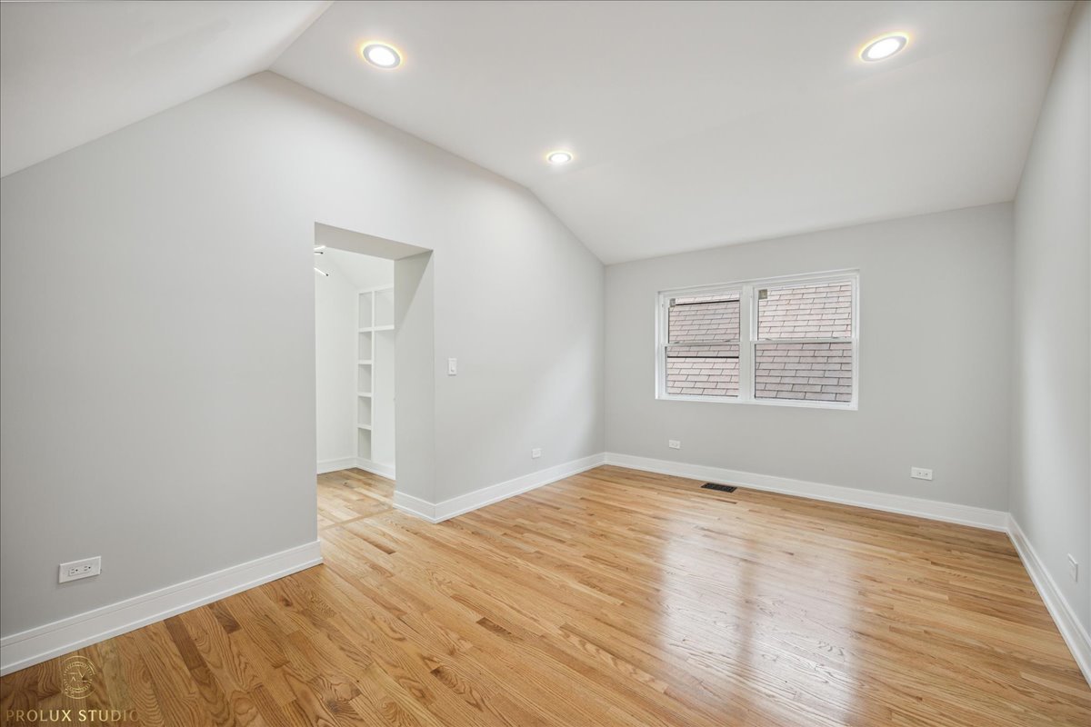 6637 South Marquette Road Chicago, IL 60637 - Photo 7 of 22 a view of an empty room with wooden floor and a window