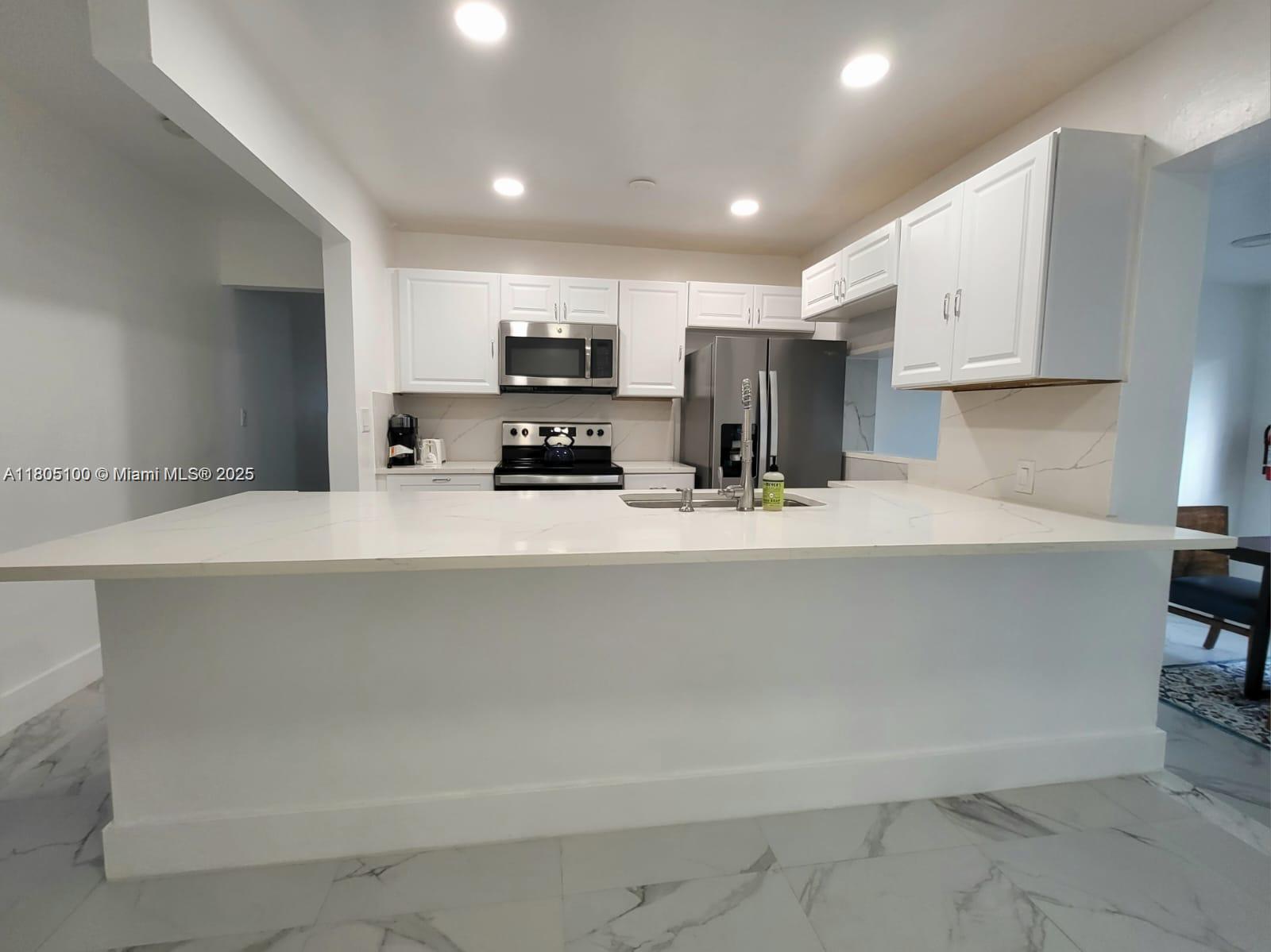 900 Southwest 31st Street Fort Lauderdale, FL 33315 - Photo 1 of 14 a kitchen with stainless steel appliances a sink a stove a microwave a refrigerator and cabinets