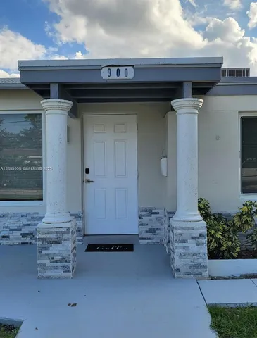 a front view of a house with a wooden fence