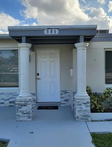 a front view of a house with a wooden fence