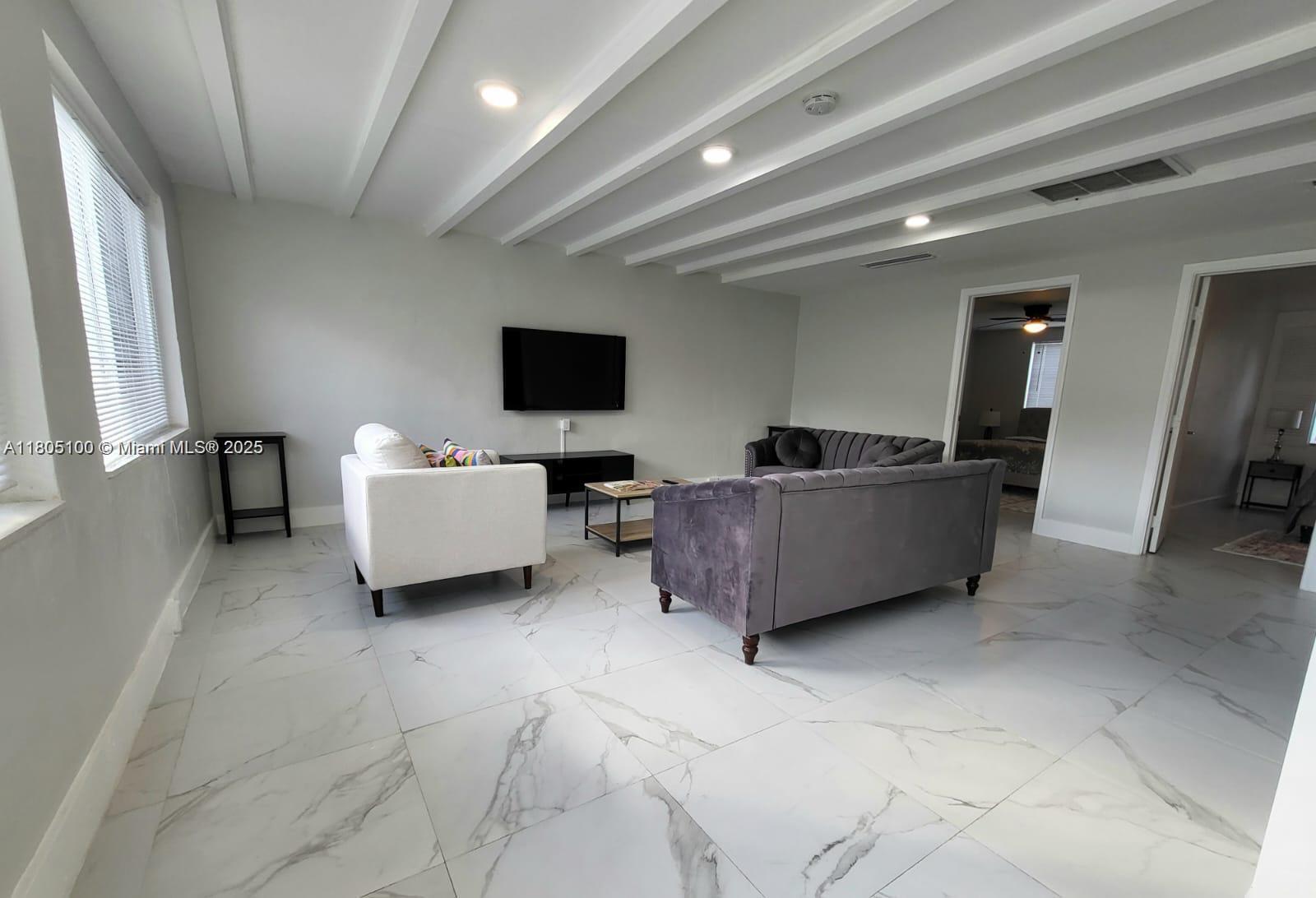 900 Southwest 31st Street Fort Lauderdale, FL 33315 - Photo 4 of 14 a living room with furniture and a flat screen tv