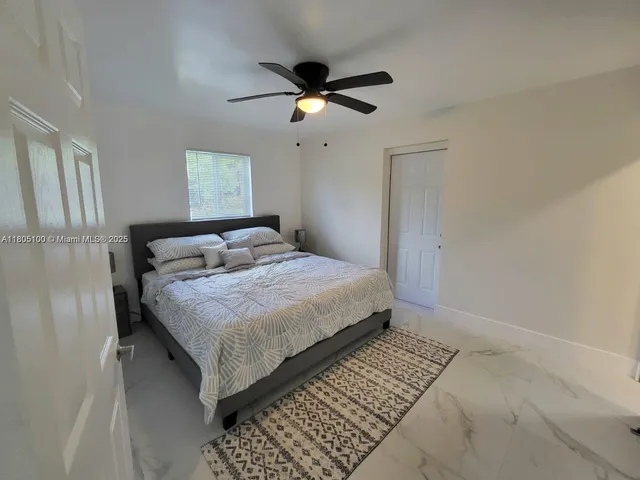 a bedroom with a bed and window