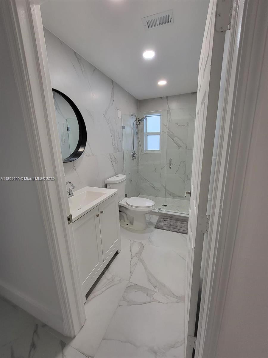 900 Southwest 31st Street Fort Lauderdale, FL 33315 - Photo 9 of 14 a bathroom with a toilet sink and mirror