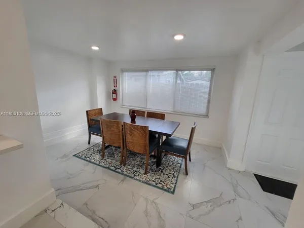 a dining room with furniture and window
