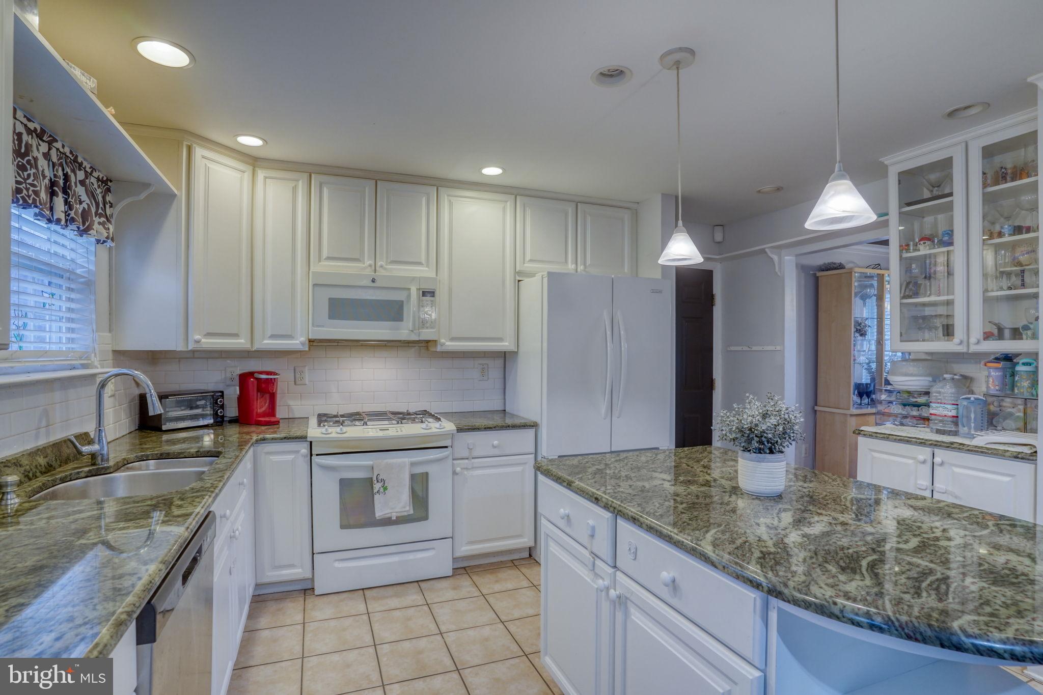 12 Bancroft Road New Castle, DE 19720 - Photo 13 of 38 a kitchen with stainless steel appliances granite countertop a sink stove and refrigerator