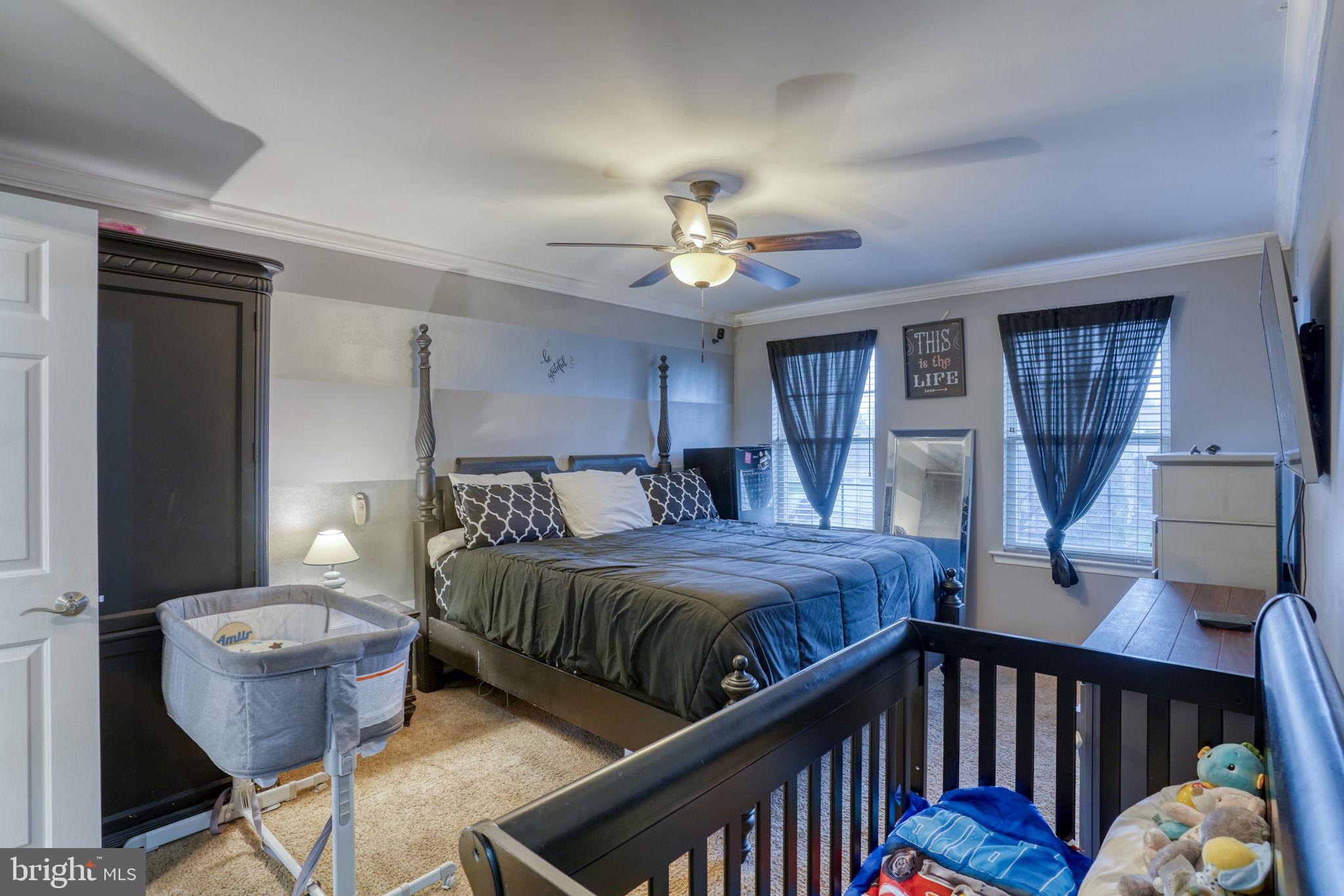 12 Bancroft Road New Castle, DE 19720 - Photo 22 of 38 a bedroom with bed and a chandelier