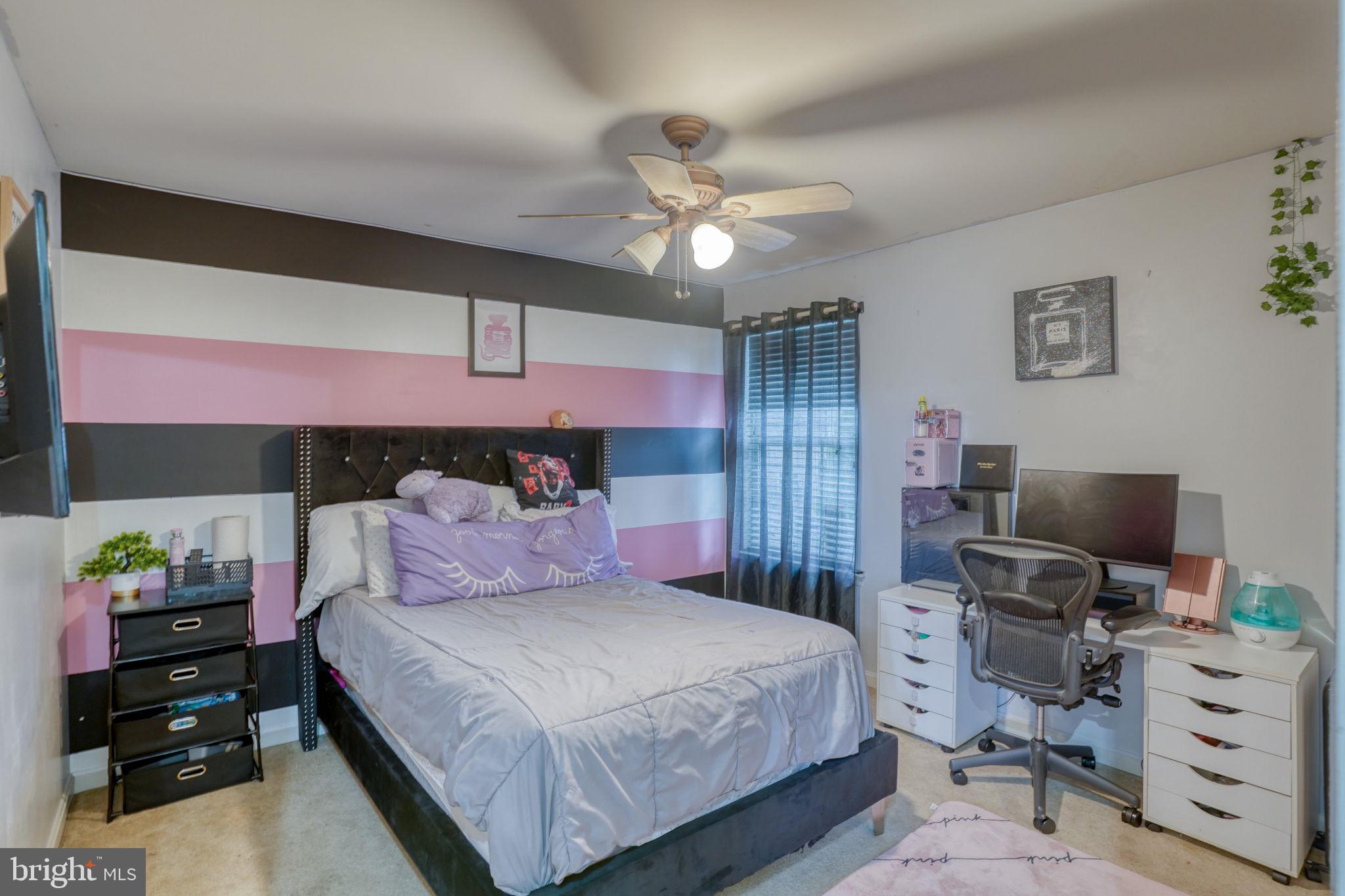12 Bancroft Road New Castle, DE 19720 - Photo 28 of 38 a bedroom with a bed and a chandelier