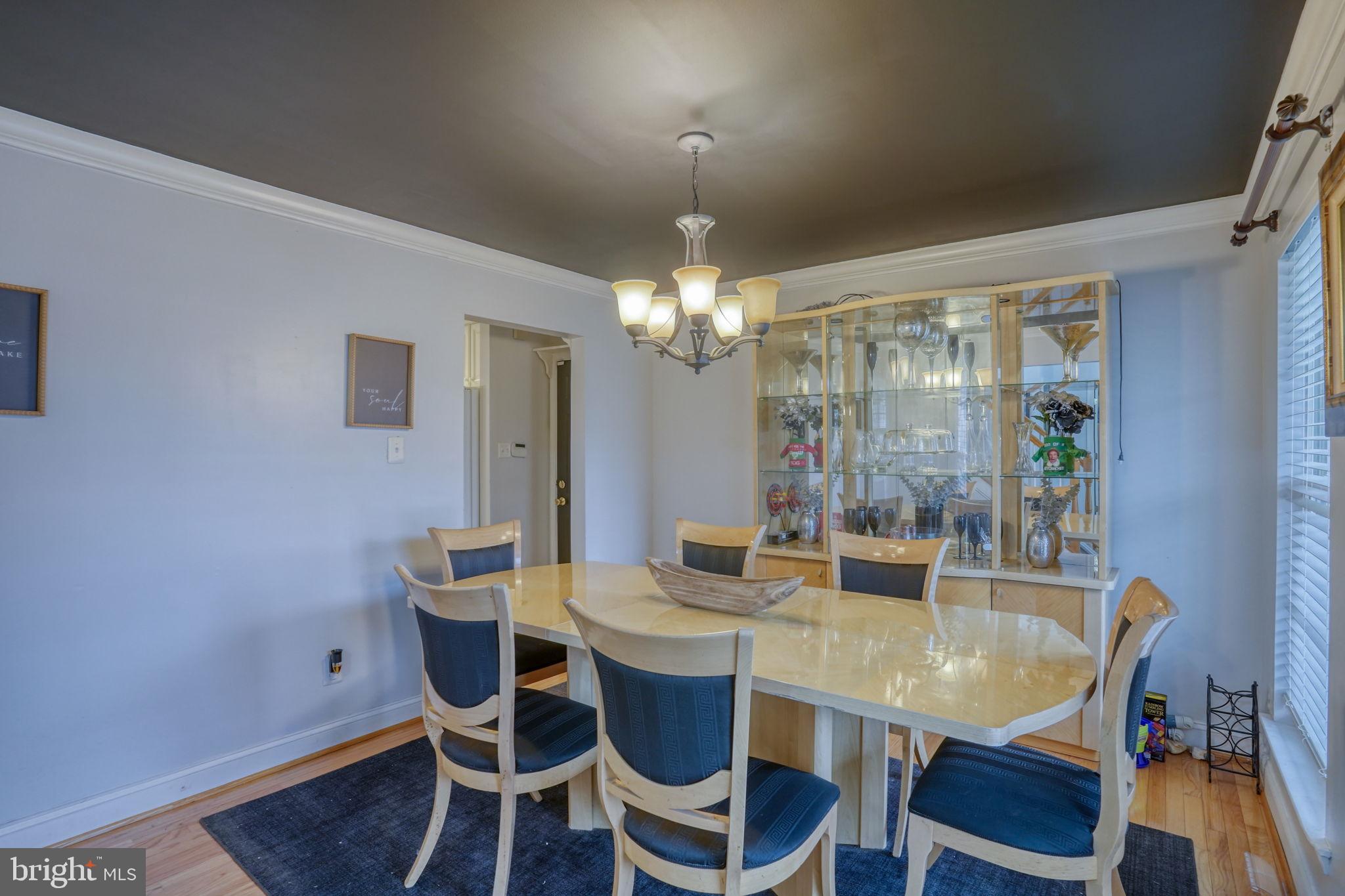 12 Bancroft Road New Castle, DE 19720 - Photo 7 of 38 a view of a dining room with furniture wooden floor and chandelier