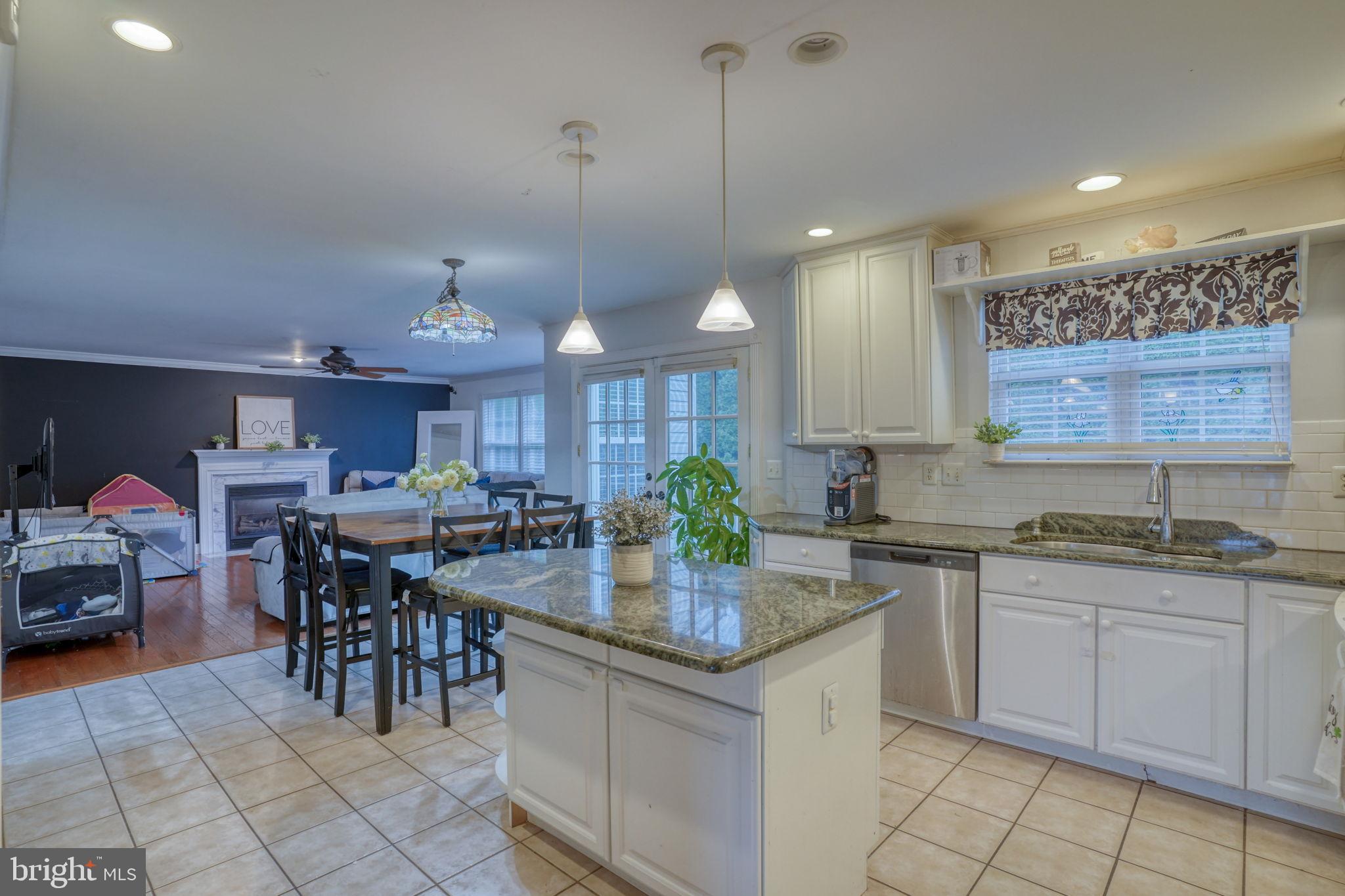 12 Bancroft Road New Castle, DE 19720 - Photo 10 of 38 a kitchen with kitchen island granite countertop a sink a counter top space and appliances