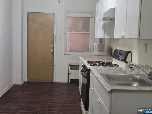 a kitchen with a sink stove and cabinets