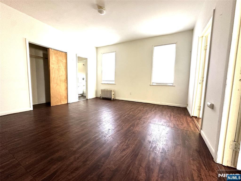 528 Valley Brook Avenue, Unit 2ND FLOOR FR Lyndhurst, NJ 07071 - Photo 3 of 8 an empty room with wooden floor and windows