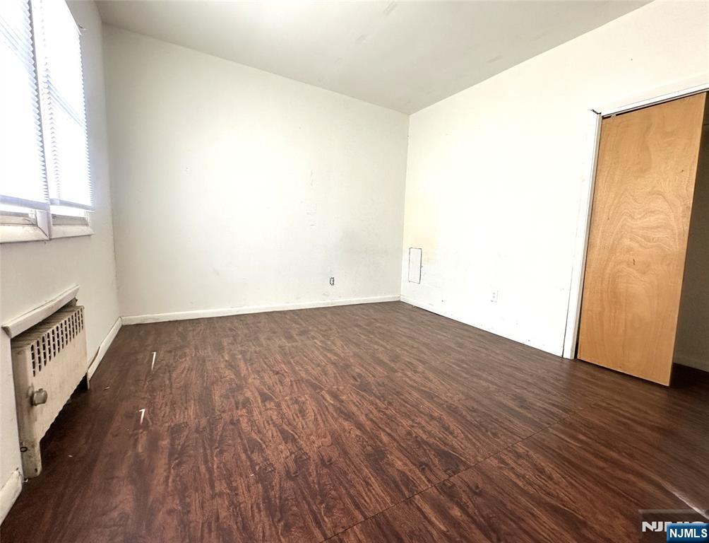 528 Valley Brook Avenue, Unit 2ND FLOOR FR Lyndhurst, NJ 07071 - Photo 4 of 8 an empty room with wooden floor and windows