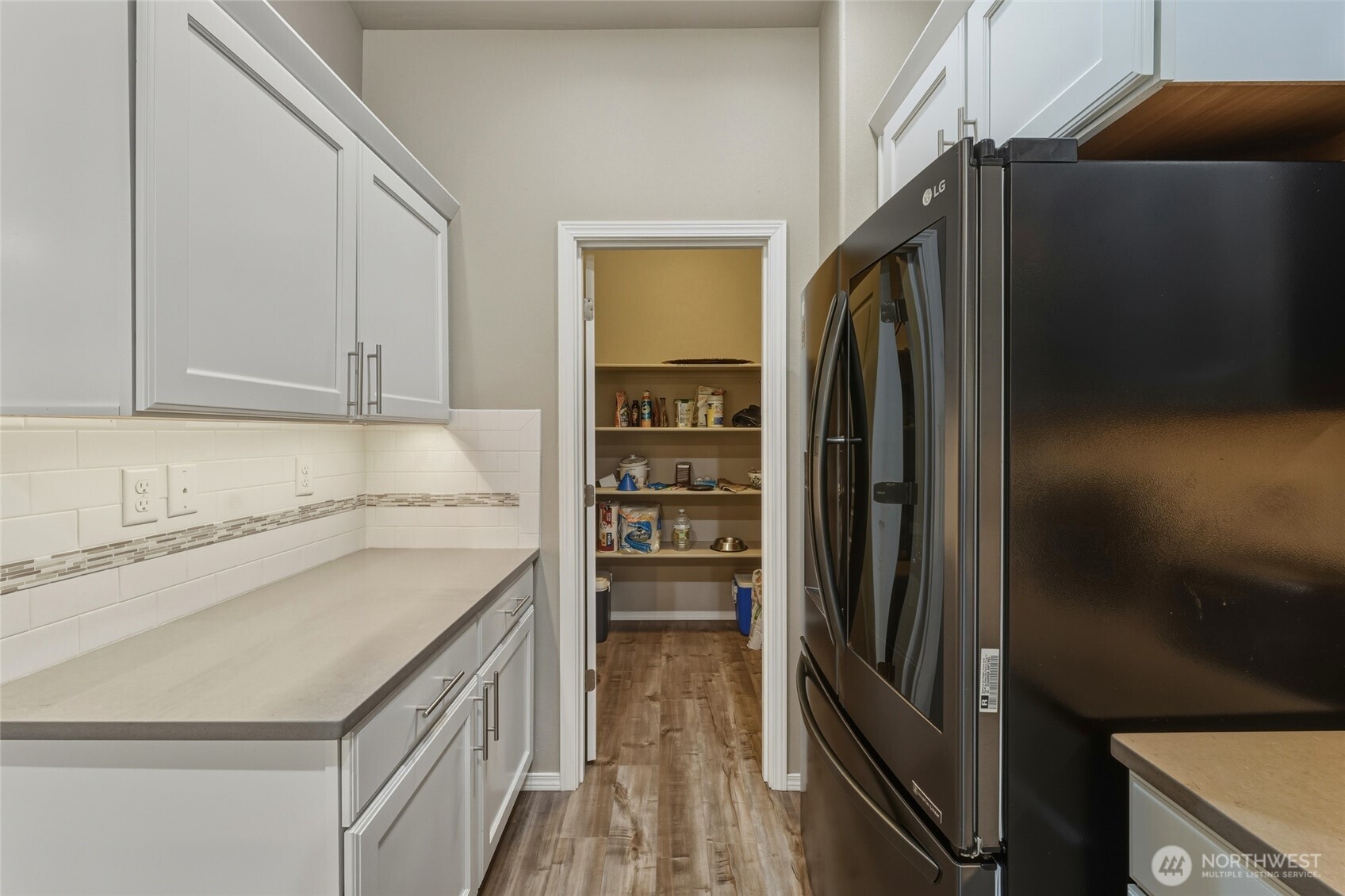 1397 Caprio Loop Walla Walla, WA 99362 - Photo 27 of 40 a kitchen with a refrigerator and a sink