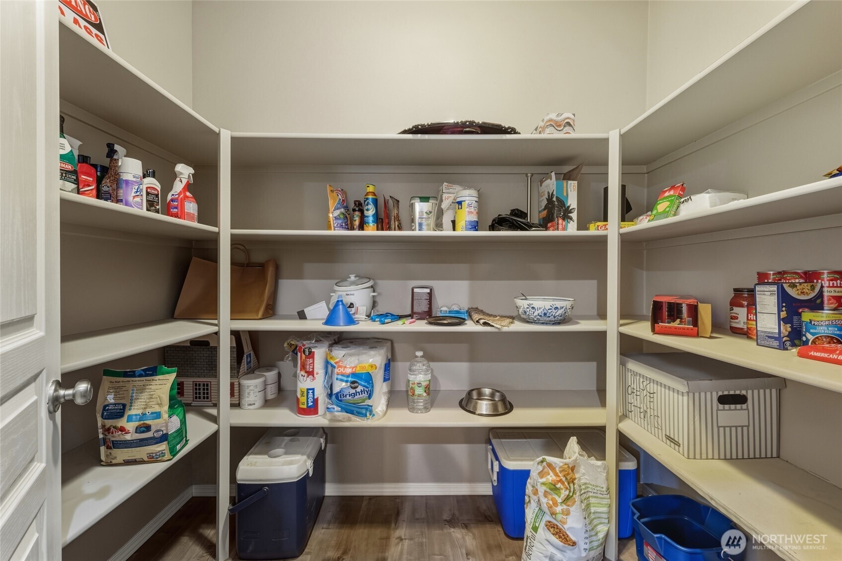 1397 Caprio Loop Walla Walla, WA 99362 - Photo 28 of 40 a room with a wooden floor and shelves